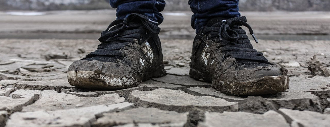 A person wearing dirty running shoes